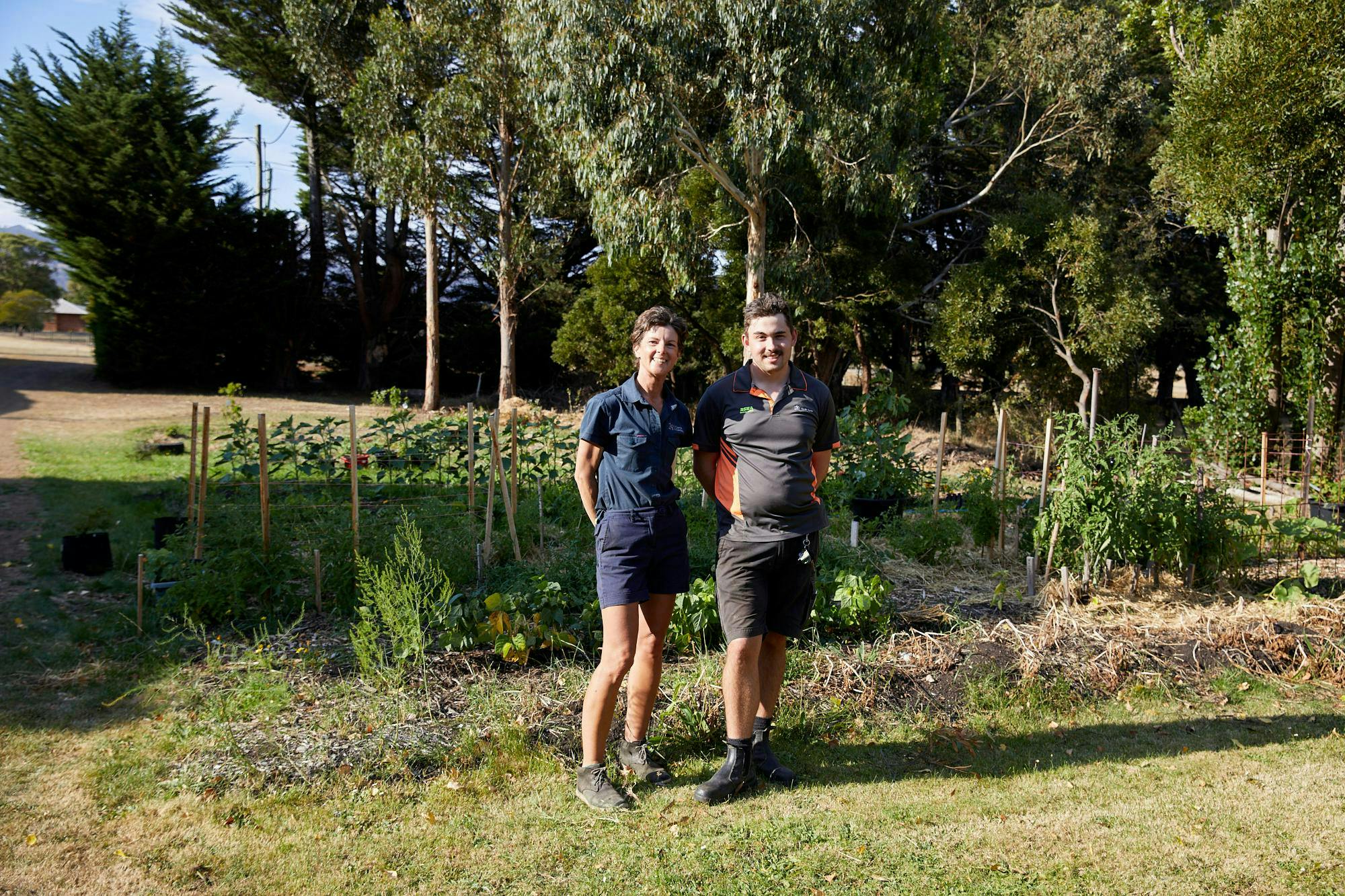 Kris and Ryan in front of some newly established garden beds in Ryan's own garden.